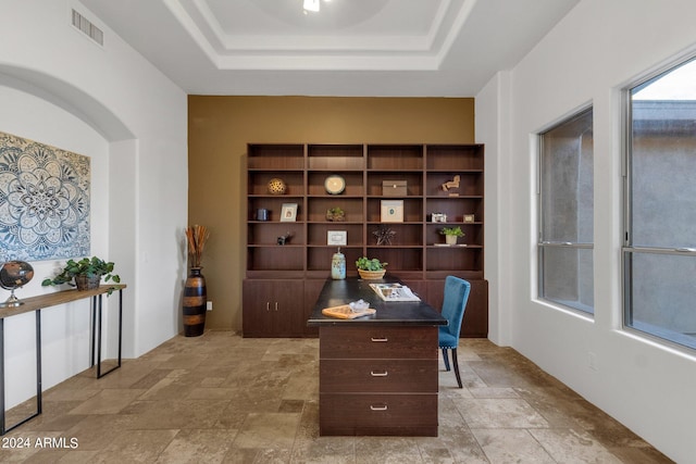 home office featuring a tray ceiling