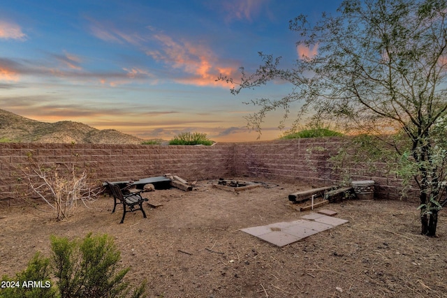 yard at dusk featuring a mountain view