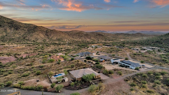 aerial view at dusk featuring a mountain view