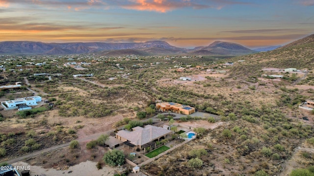 aerial view at dusk featuring a mountain view