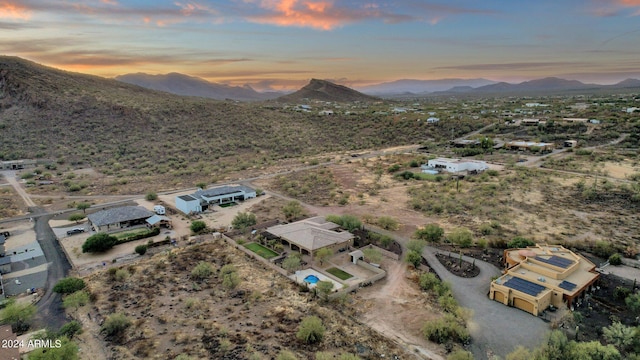 aerial view at dusk featuring a mountain view