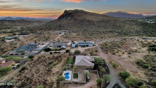 aerial view at dusk featuring a mountain view