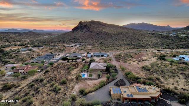 aerial view at dusk featuring a mountain view