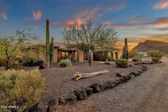 back house at dusk featuring a mountain view