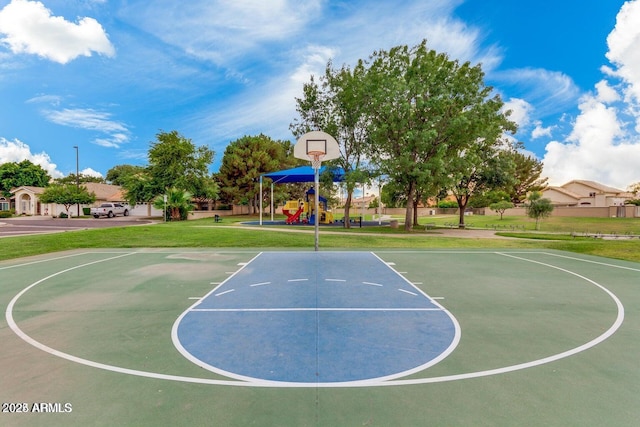 view of basketball court featuring a lawn and a playground