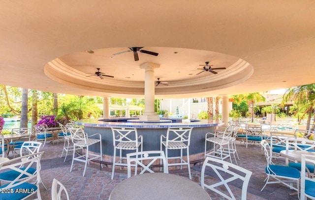 view of patio with exterior bar and ceiling fan