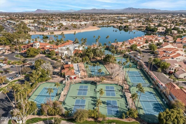 birds eye view of property with a water and mountain view