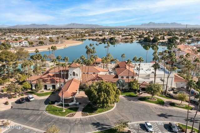 birds eye view of property with a water and mountain view