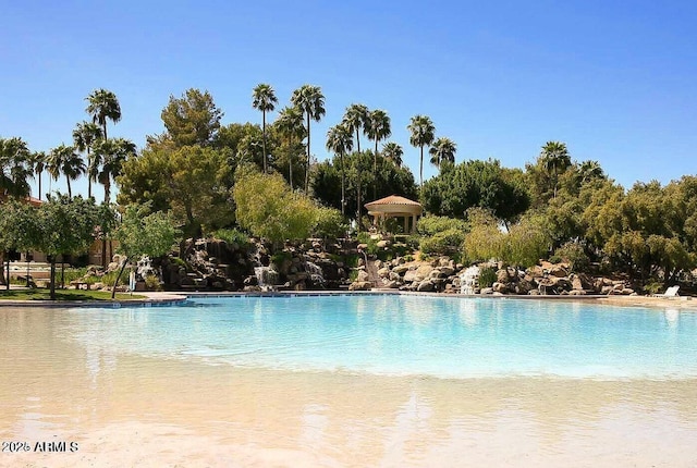 view of swimming pool featuring a water view