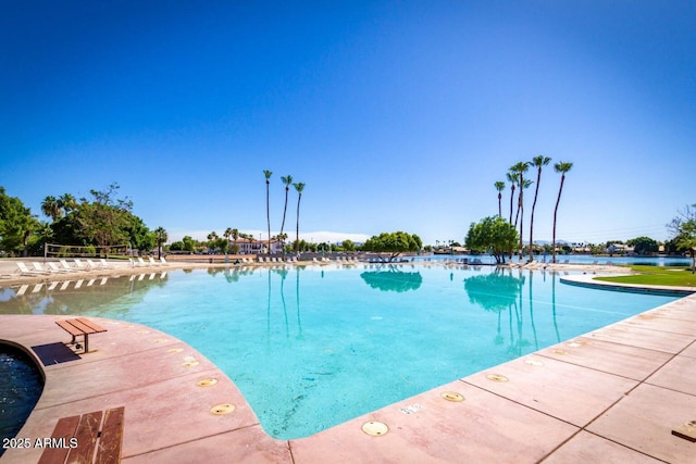 view of swimming pool with a water view