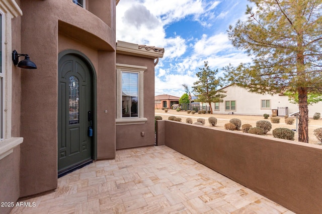 1407 E Artemis Trl, San Tan Valley, AZ 85140 - view of exterior entry featuring a balcony and stucco siding