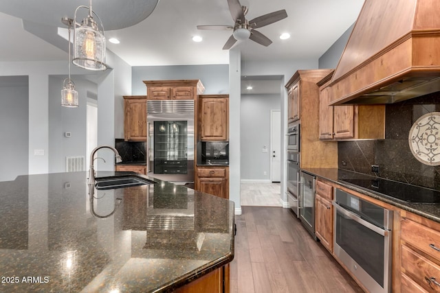 1407 E Artemis Trl, San Tan Valley, AZ 85140 - kitchen with dark wood finished floors, custom exhaust hood, a sink, built in fridge, and black electric stovetop