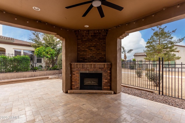 1407 E Artemis Trl, San Tan Valley, AZ 85140 - view of patio with fence, an outdoor brick fireplace, and ceiling fan