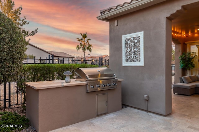 1407 E Artemis Trl, San Tan Valley, AZ 85140 - patio terrace at dusk with area for grilling and fence