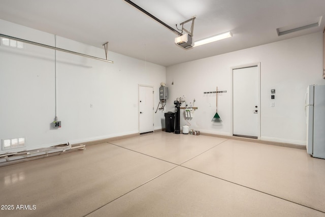 1407 E Artemis Trl, San Tan Valley, AZ 85140 - garage with baseboards, a garage door opener, and freestanding refrigerator