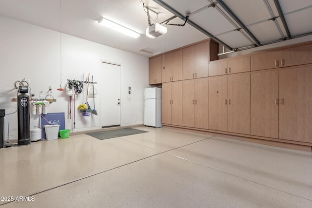 1407 E Artemis Trl, San Tan Valley, AZ 85140 - garage featuring a garage door opener and freestanding refrigerator