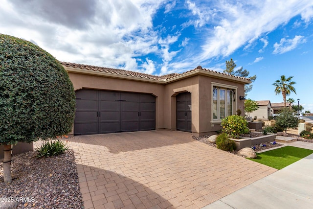 1407 E Artemis Trl, San Tan Valley, AZ 85140 - mediterranean / spanish-style home with a tiled roof, stucco siding, an attached garage, and decorative driveway
