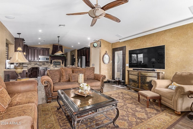 living room featuring ceiling fan and vaulted ceiling