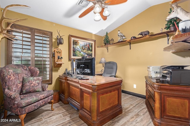 office space featuring ceiling fan, lofted ceiling, and light hardwood / wood-style flooring