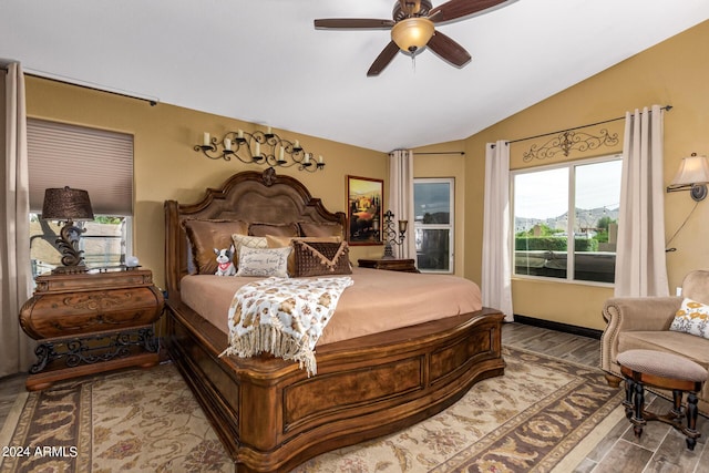 bedroom with multiple windows, hardwood / wood-style flooring, ceiling fan, and lofted ceiling