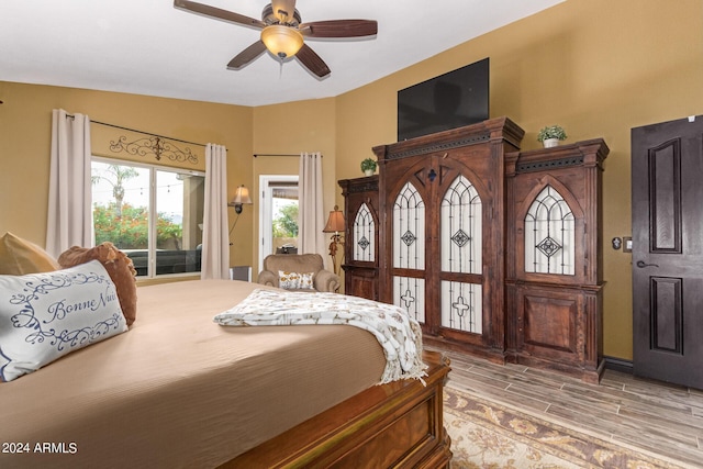 bedroom with hardwood / wood-style flooring and ceiling fan