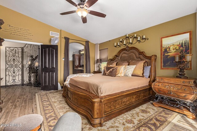 bedroom with hardwood / wood-style flooring, vaulted ceiling, and ceiling fan