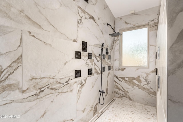 bathroom with a tile shower