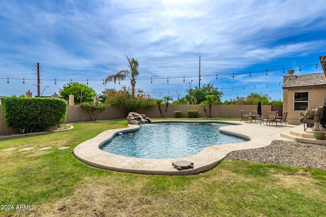 view of swimming pool featuring a lawn and a patio area