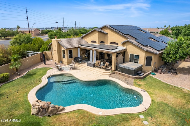 view of pool with a yard, a hot tub, and a patio area