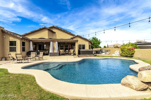 view of swimming pool featuring a patio area and a hot tub