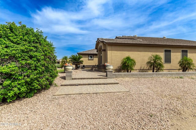 view of side of home featuring a patio area