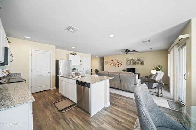 620 Vista Del Rio Ct, Wickenburg, AZ 85390 - kitchen featuring visible vents, appliances with stainless steel finishes, dark wood-style floors, and white cabinetry