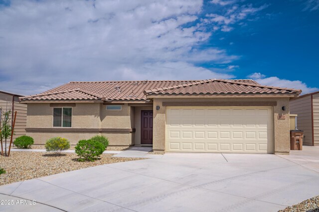620 Vista Del Rio Ct, Wickenburg, AZ 85390 - mediterranean / spanish house with stucco siding, an attached garage, concrete driveway, and a tiled roof