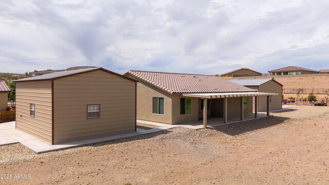 620 Vista Del Rio Ct, Wickenburg, AZ 85390 - rear view of house with fence, stucco siding, a patio area, a tile roof, and an outdoor structure
