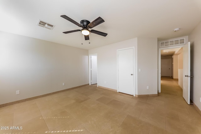 unfurnished bedroom featuring light tile patterned floors, baseboards, visible vents, and ceiling fan