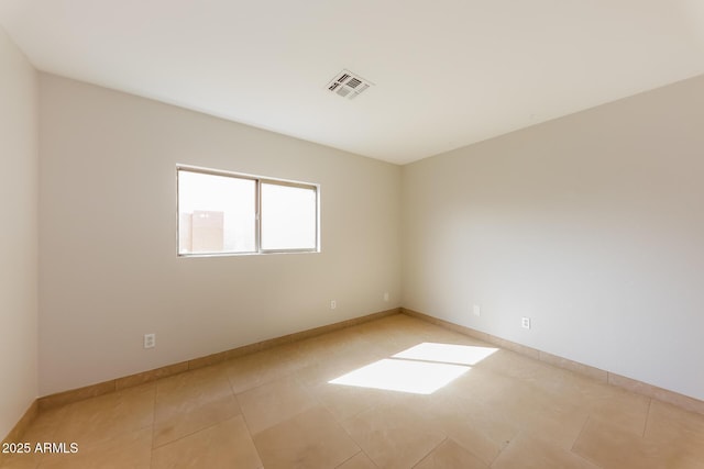 unfurnished room featuring light tile patterned floors, baseboards, and visible vents