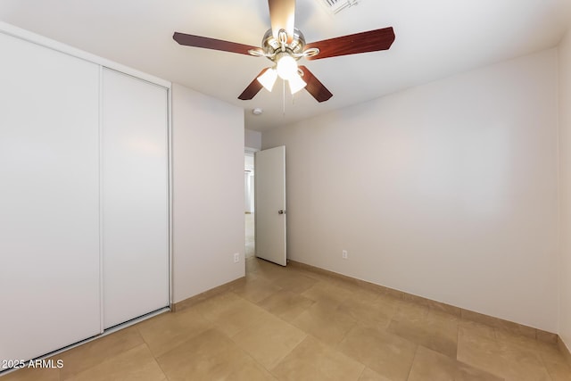 unfurnished bedroom featuring visible vents, a ceiling fan, and a closet