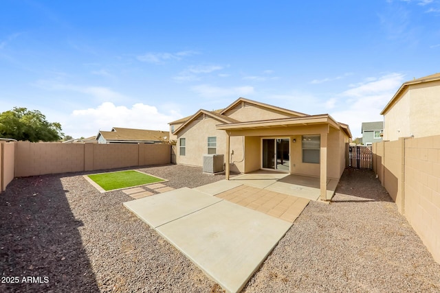 back of property featuring a patio area, central AC unit, stucco siding, and a fenced backyard