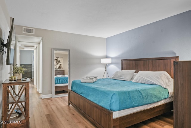 bedroom with light hardwood / wood-style floors