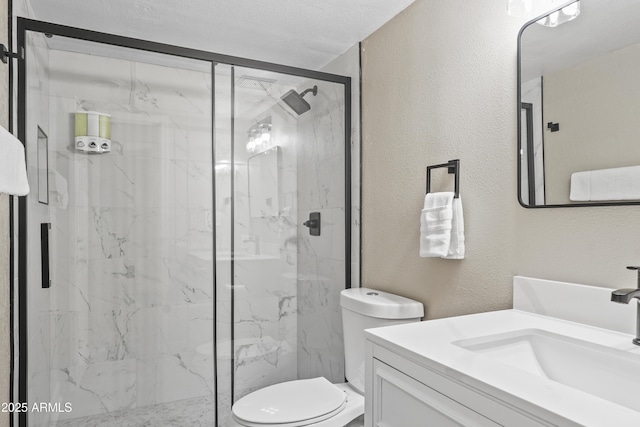 bathroom featuring vanity, an enclosed shower, a textured ceiling, and toilet