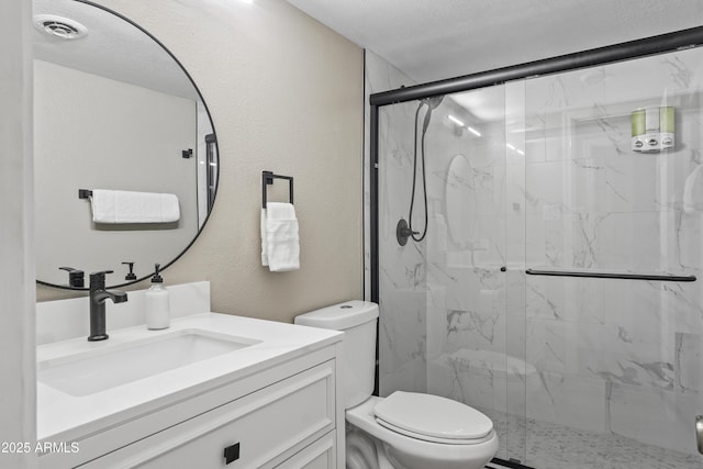 bathroom featuring vanity, walk in shower, a textured ceiling, and toilet