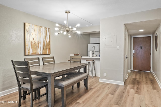 dining room featuring light hardwood / wood-style flooring and a chandelier