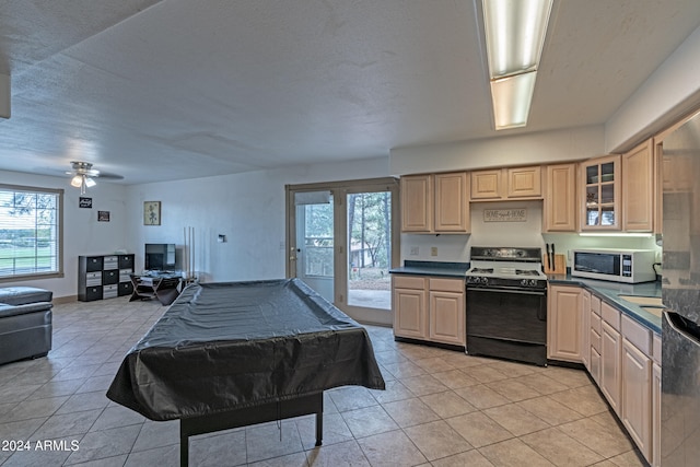 kitchen with pool table, ceiling fan, light brown cabinetry, black range oven, and light tile patterned floors