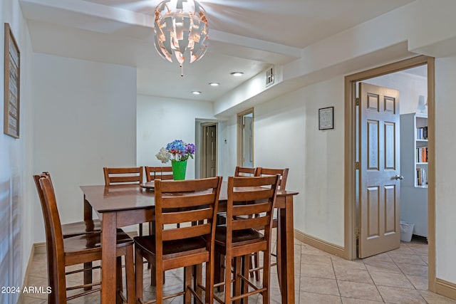 dining space featuring a notable chandelier and light tile patterned floors