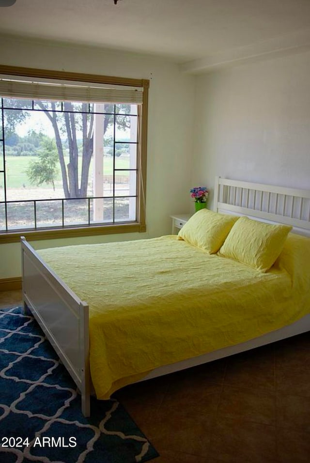 bedroom featuring dark tile patterned flooring