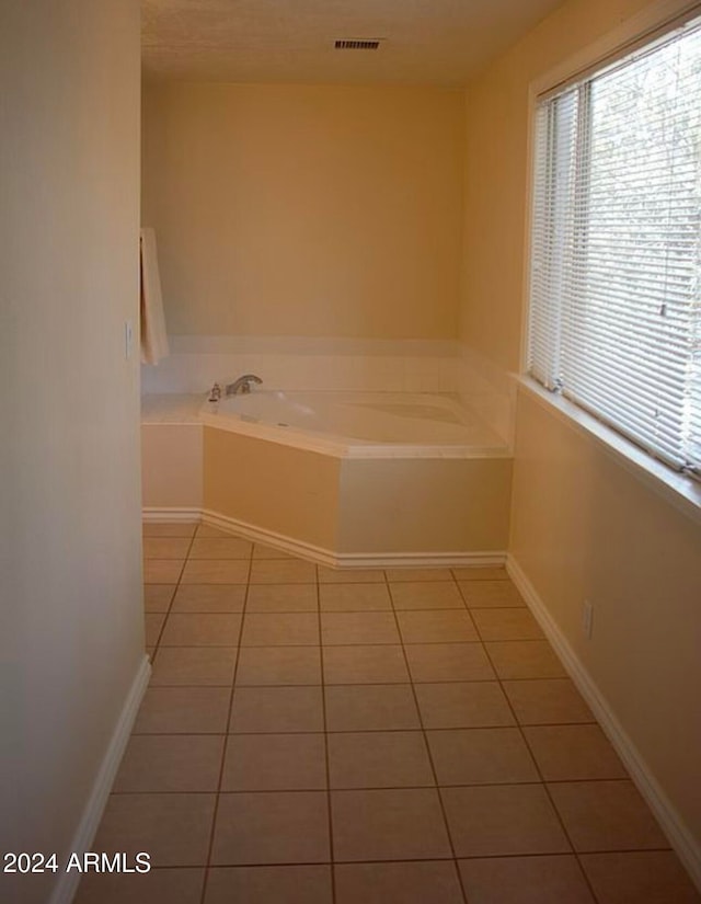 bathroom featuring tile patterned flooring and a washtub