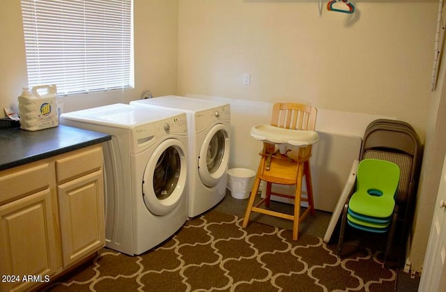 washroom with dark colored carpet, washing machine and clothes dryer, and cabinets