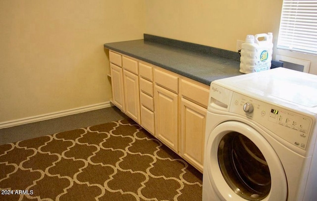 washroom featuring washer / dryer, dark carpet, and cabinets