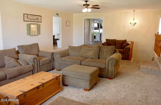 living room featuring carpet, a textured ceiling, and ceiling fan