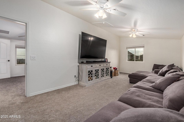 carpeted living area with attic access, visible vents, ceiling fan, and baseboards